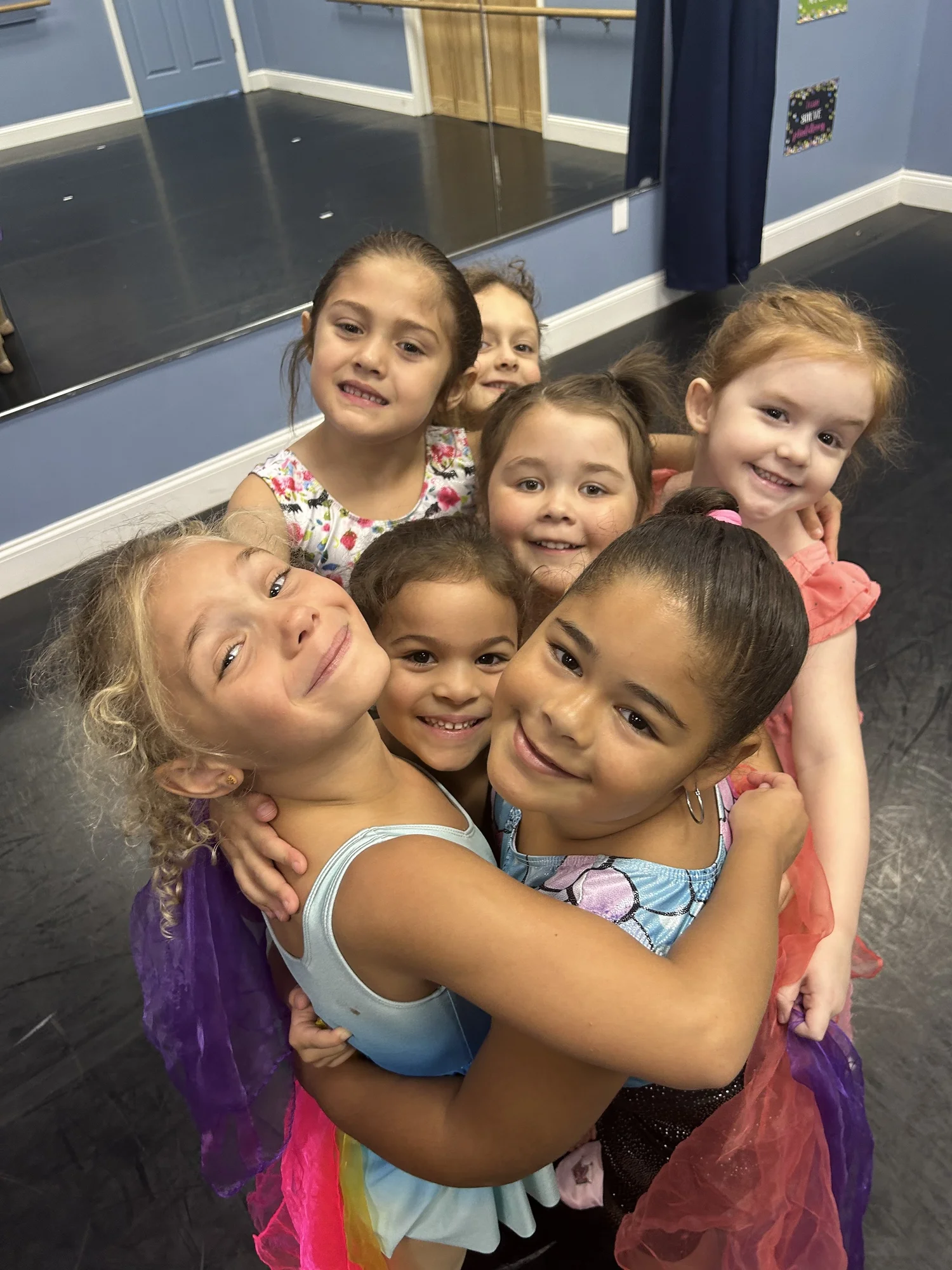 Rising Stars dancers smiling together at the studio